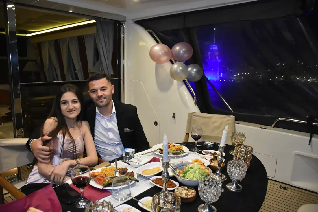 Couple at an anniversary dinner in a yacht saloon
