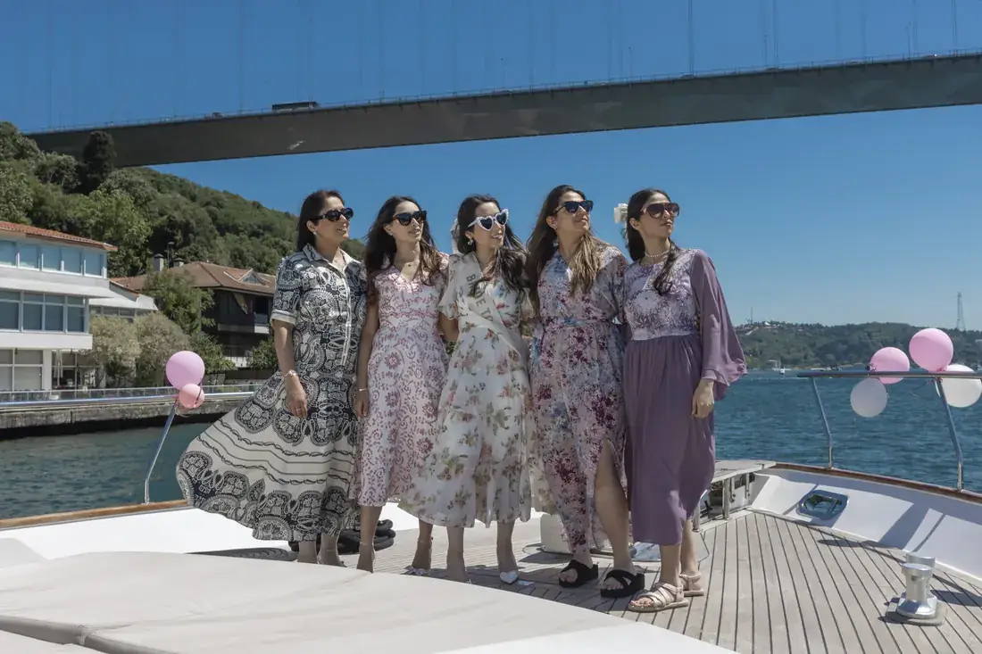 Bachelorette group on the bow of a yacht near the bridge
