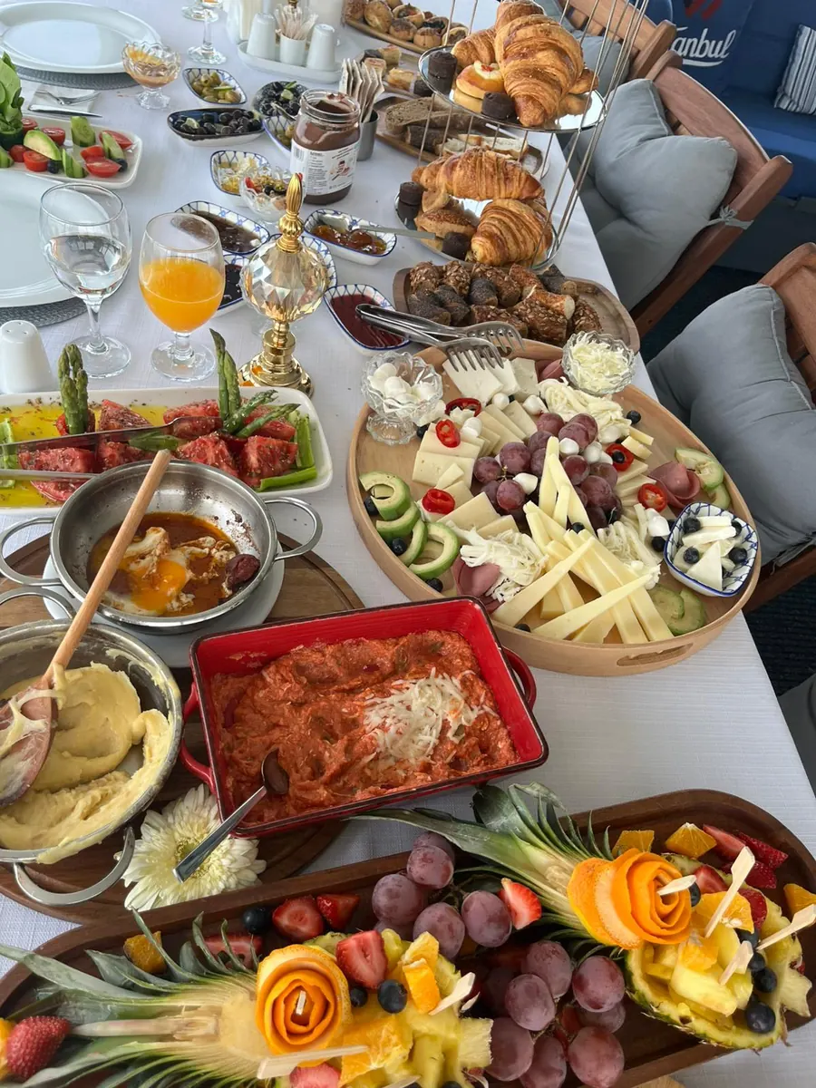Cheeses, pastries and fresh fruit for breakfast on board