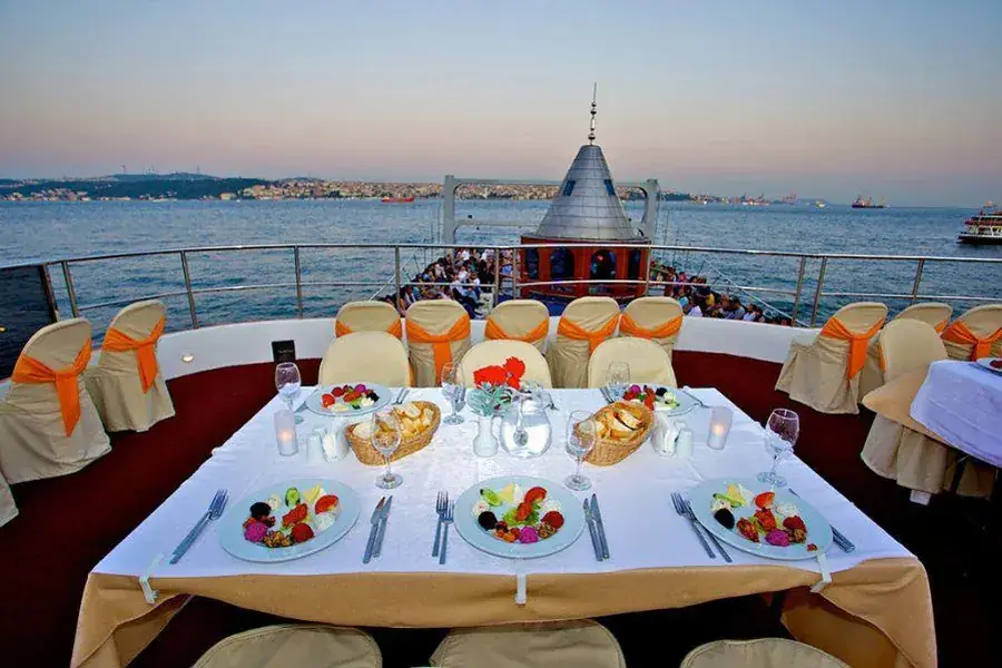 VIP table on the top deck of the dinner cruise boat at dusk