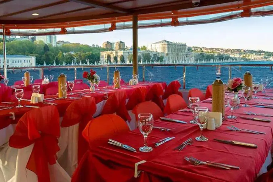 Lunch tables set by the windows with Dolmabahçe Palace across the water