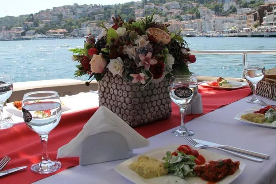 Table with flowers and wine glasses on the lunch boat