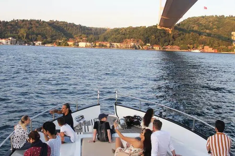 Guests on the bow sailing under the Bosphorus Bridge