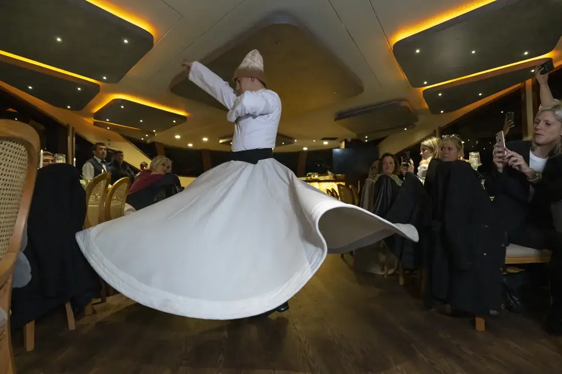 Whirling dervish show in a yacht saloon