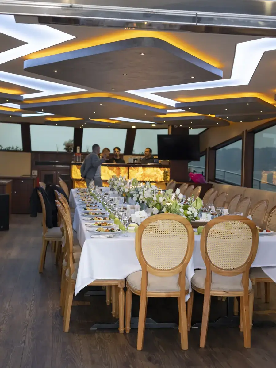 Dinner tables set in a yacht saloon