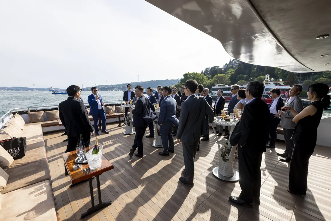 Cocktail reception on the open deck of an event yacht