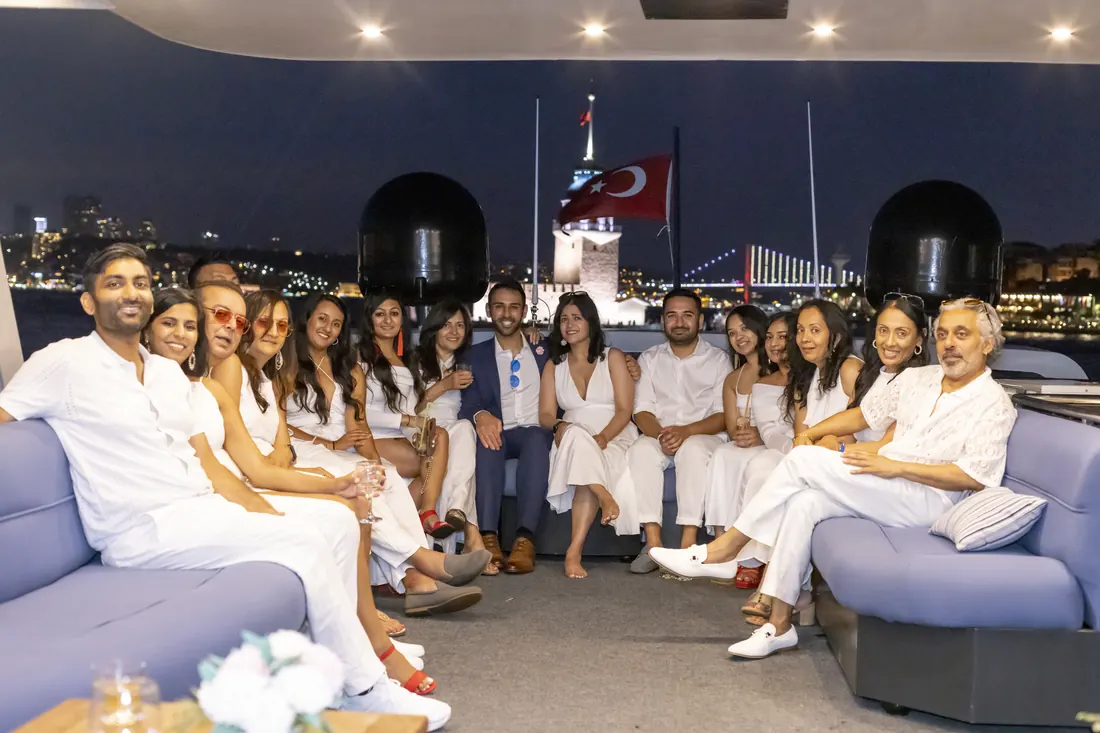 Company group on a yacht at night with the Istanbul lights
