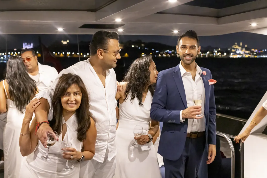 Guests at a white party in a yacht saloon