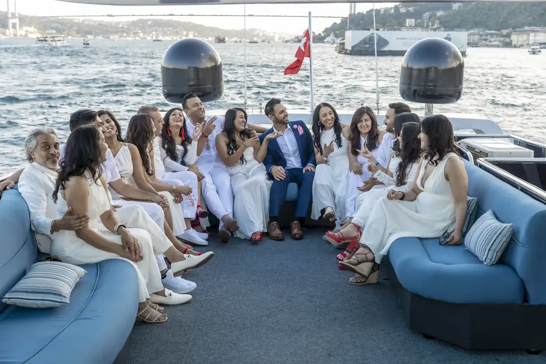White party guests relaxing on the deck of a yacht