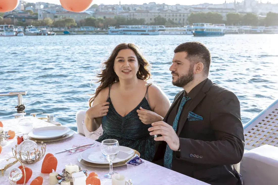Couple at a family celebration on a yacht by day
