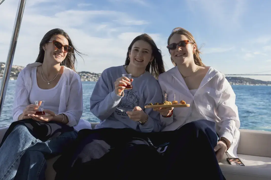 Friends with drinks and snacks on a yacht