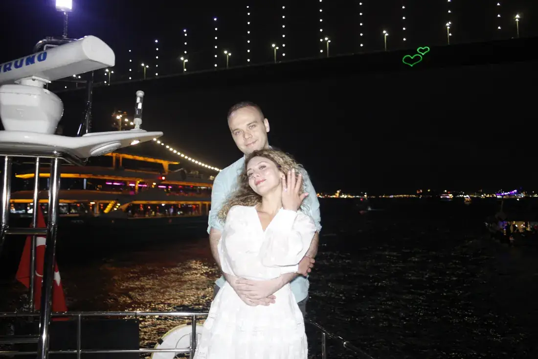 Couple embracing on a yacht at night in Istanbul