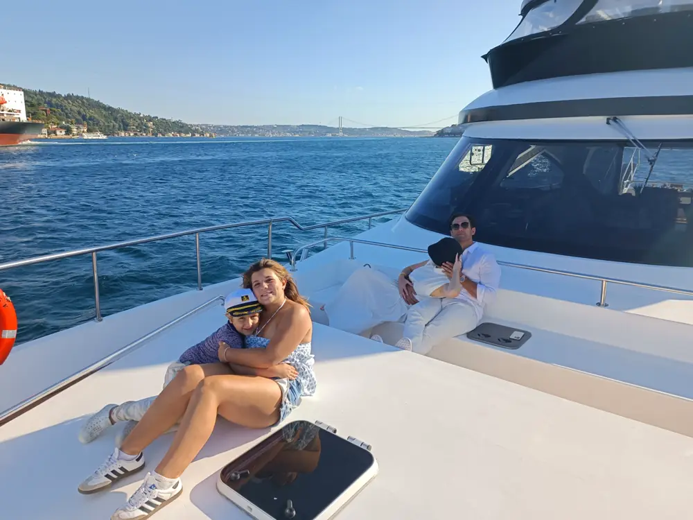 Family relaxing on the sun deck of a private yacht on the Bosphorus