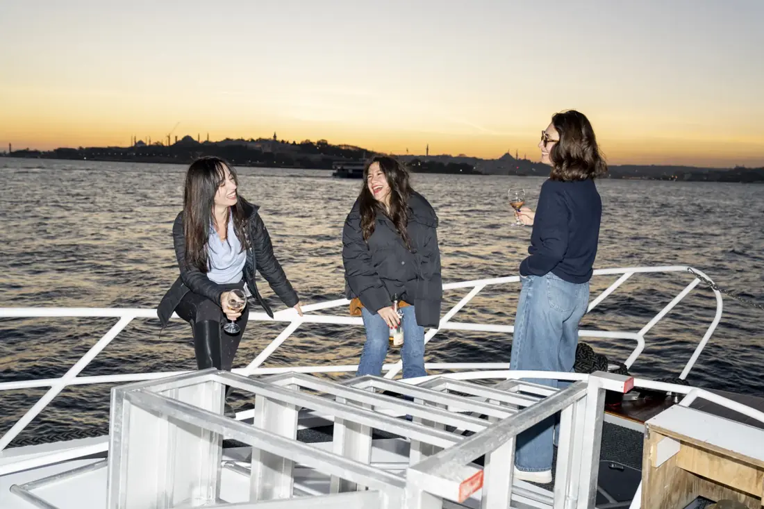 Friends on a private yacht at sunset