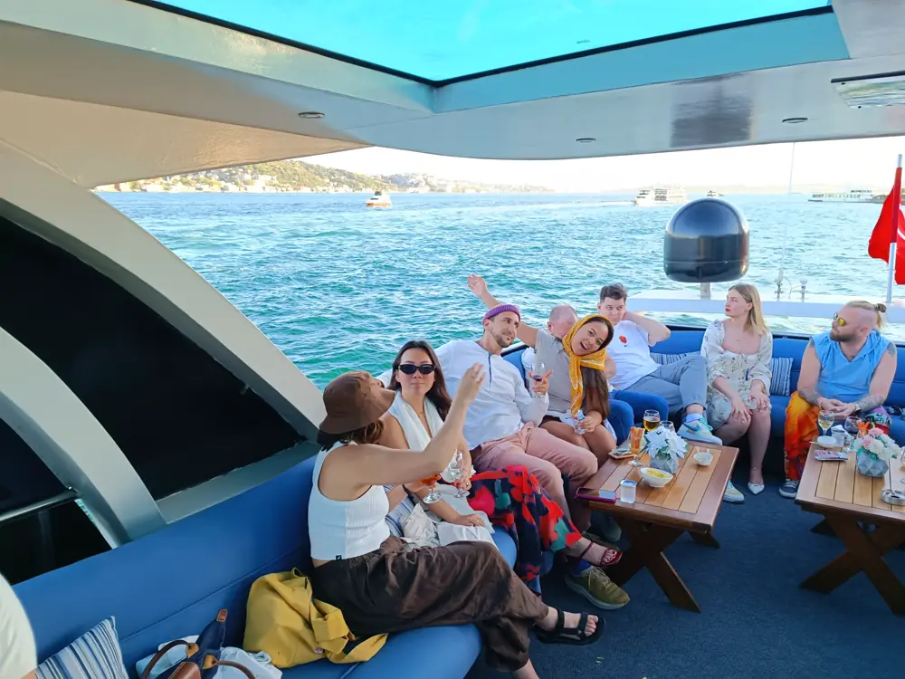 A group of friends celebrating on the deck of a private yacht in Istanbul