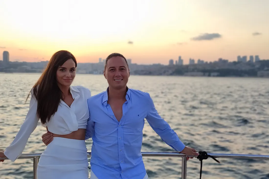Couple on a private yacht on the Bosphorus in the golden evening light