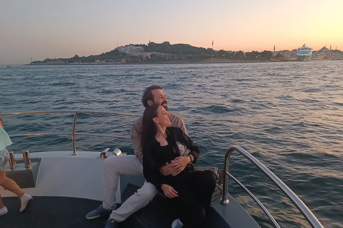 Couple on the deck of a private yacht at golden hour