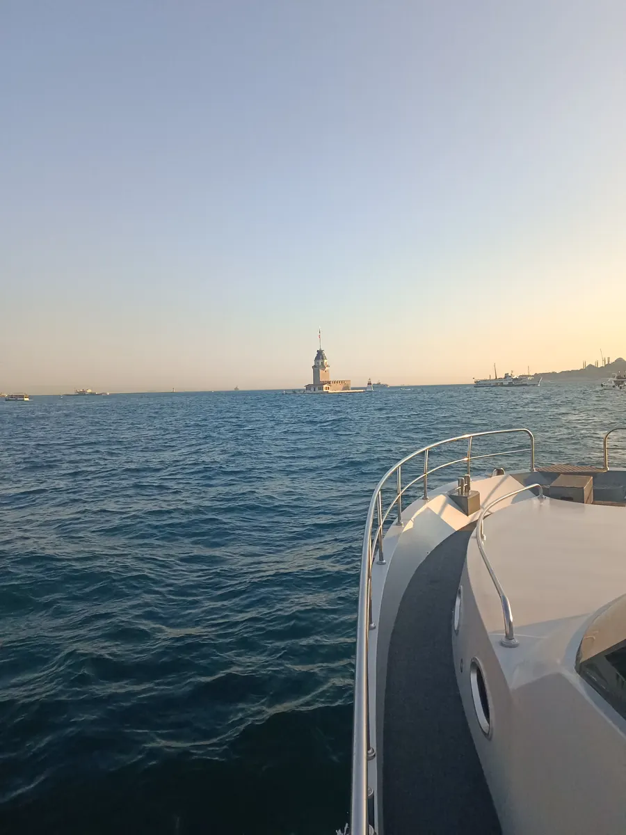The Maiden's Tower at sunset seen from the bow of a private yacht