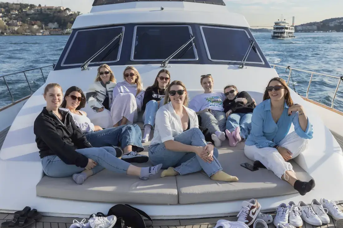 Team relaxing on the bow of a yacht on the Bosphorus