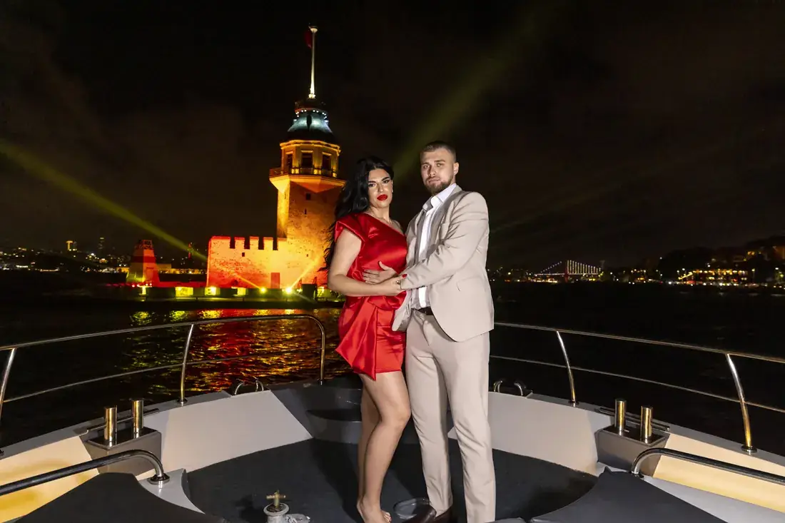Couple on a yacht by the illuminated Maiden's Tower