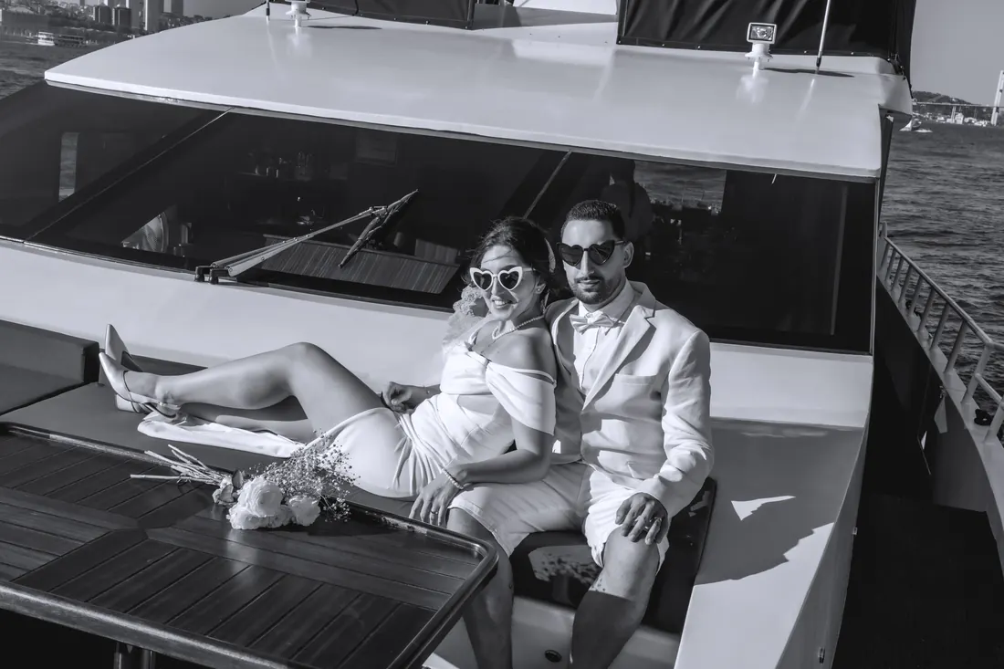 Recién casados relajándose en la cubierta de un yate en blanco y negro