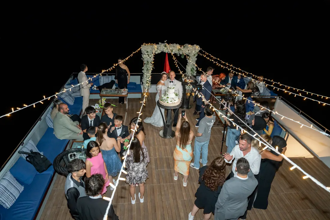Wedding party on a yacht deck at night