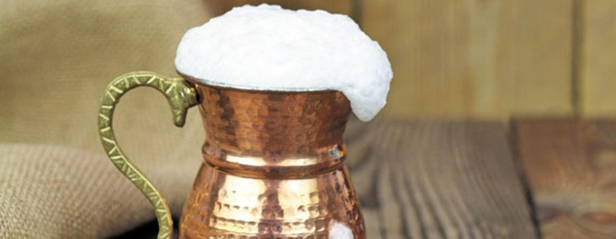 Frothy ayran yoghurt drink in a glass