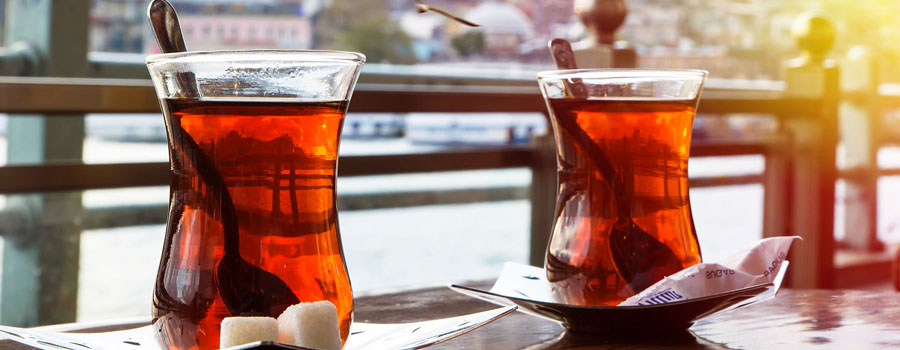 Turkish tea in a tulip-shaped glass on a saucer