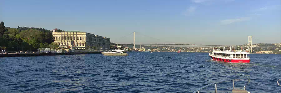 Cruise boat on the Bosphorus passing palaces on the European shore
