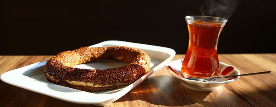 Simit sesame bread ring with a glass of Turkish tea
