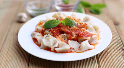 Turkish mantı dumplings with garlic yoghurt and red pepper butter