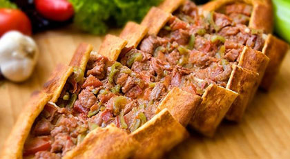 Turkish pide with cheese and minced meat from a stone oven